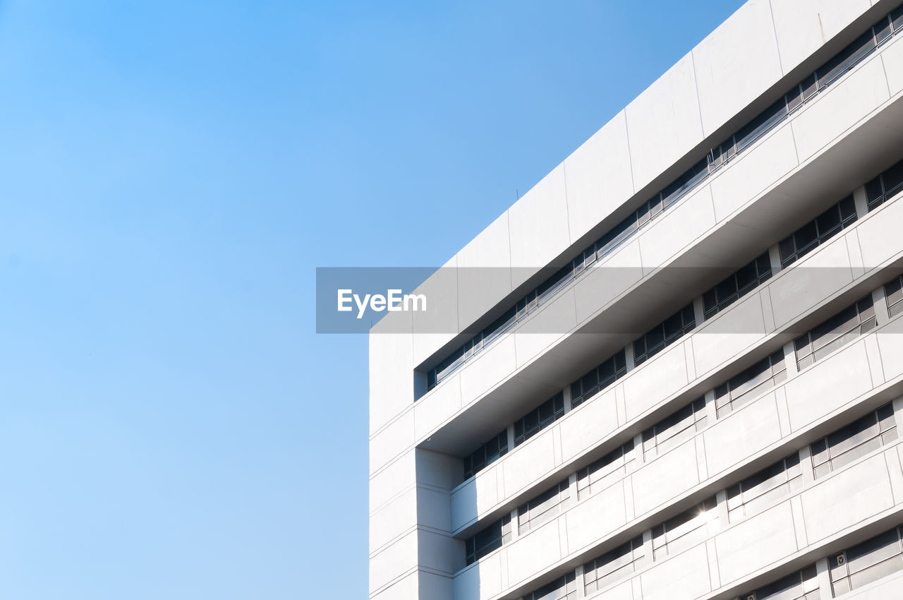 Low angle view of modern building against clear blue sky