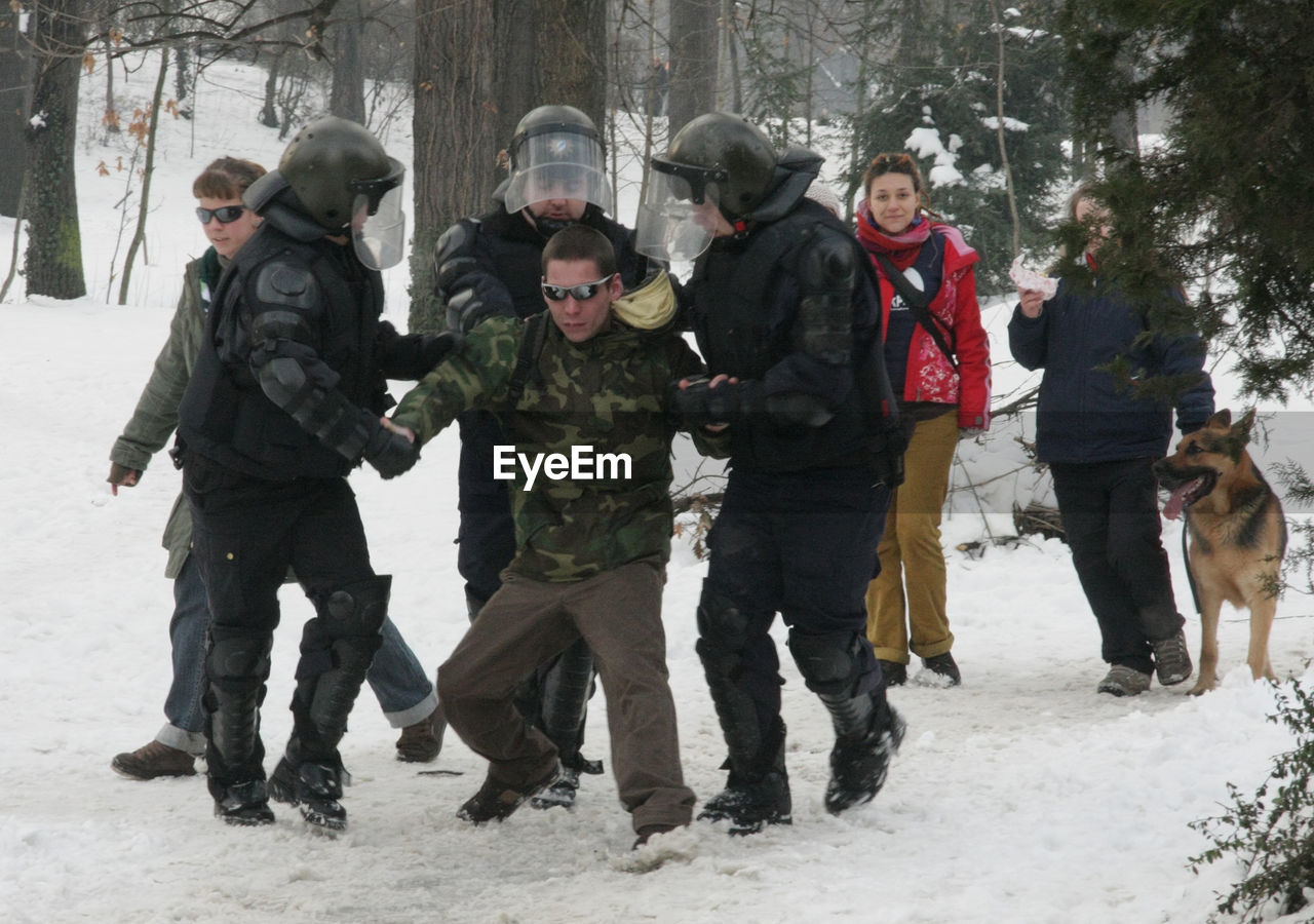 PEOPLE WALKING ON SNOW COVERED TREES