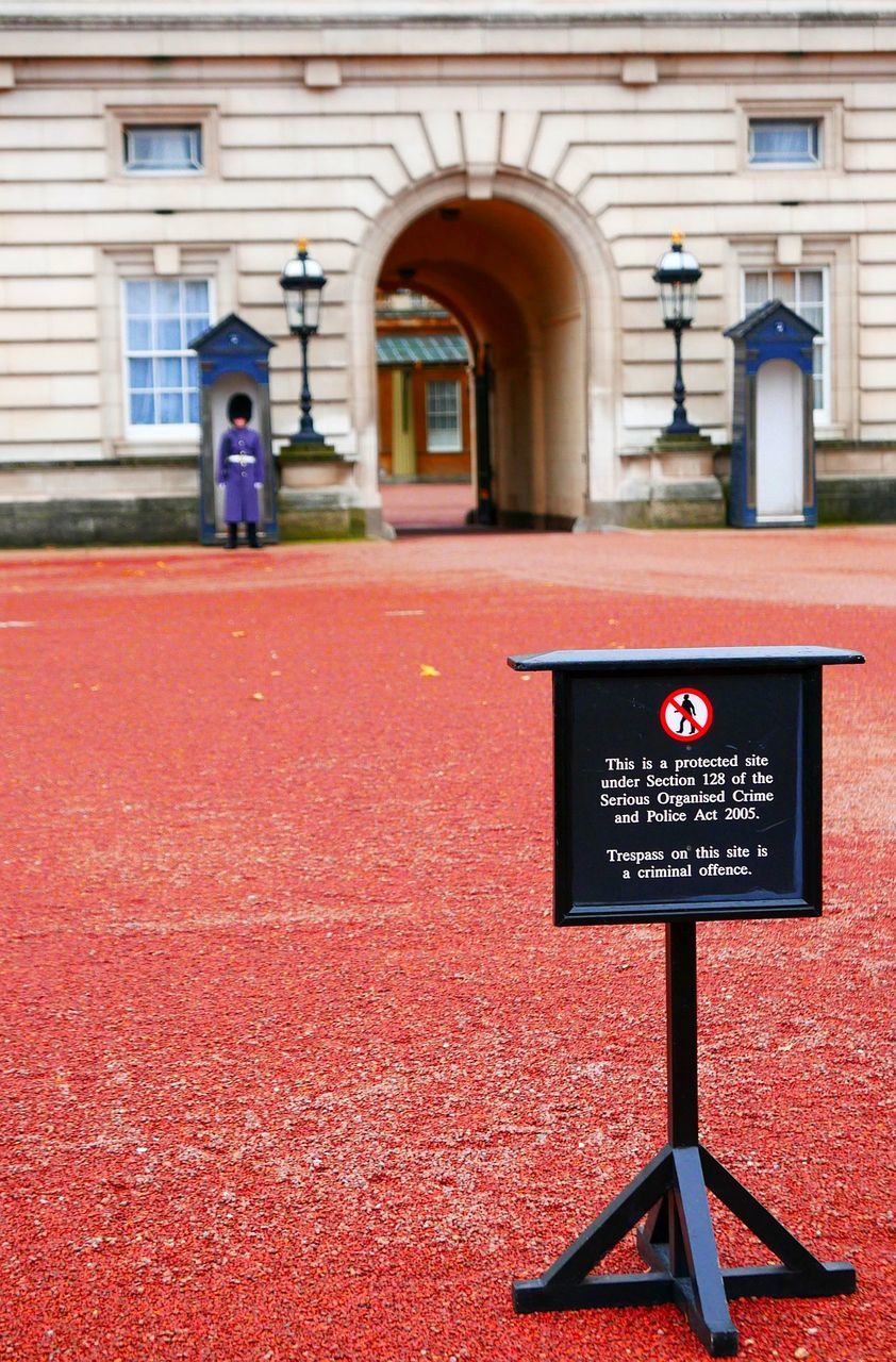 INFORMATION SIGN ON RED WALL