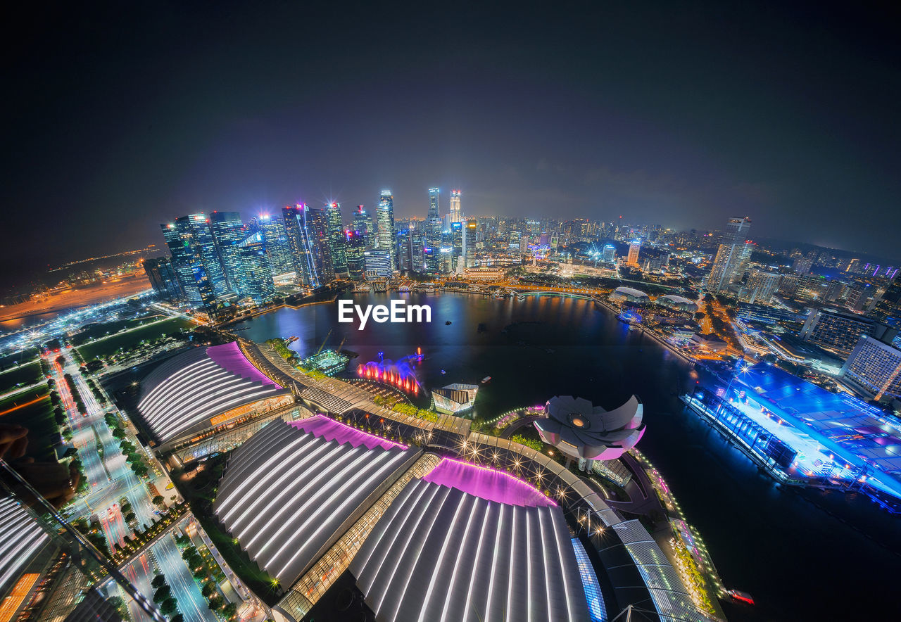 Aerial view of illuminated cityscape against sky at night