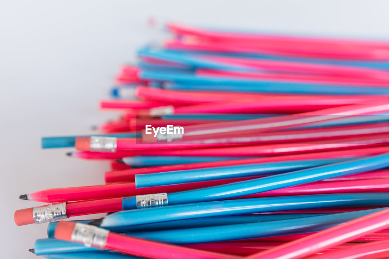 Close-up of pencils over white background