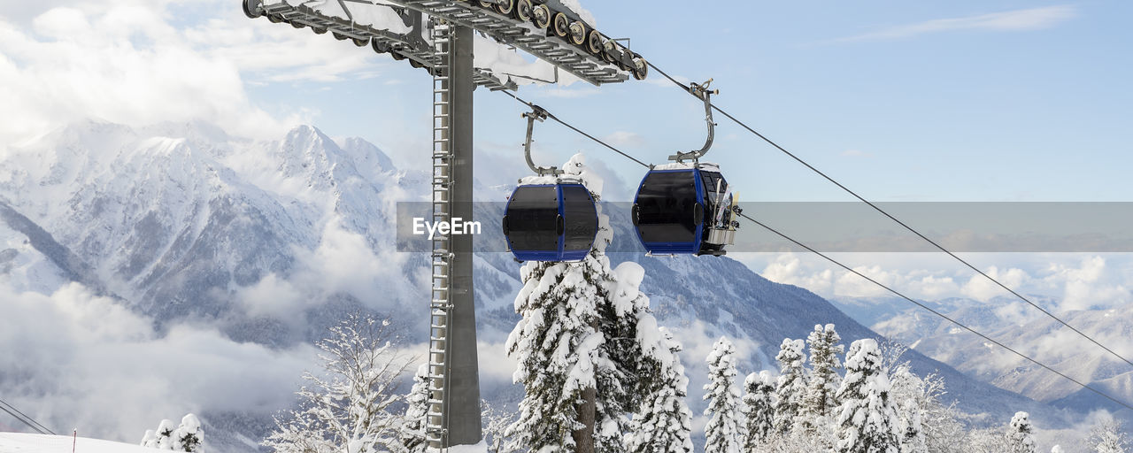 low angle view of ski on snow covered mountain against sky