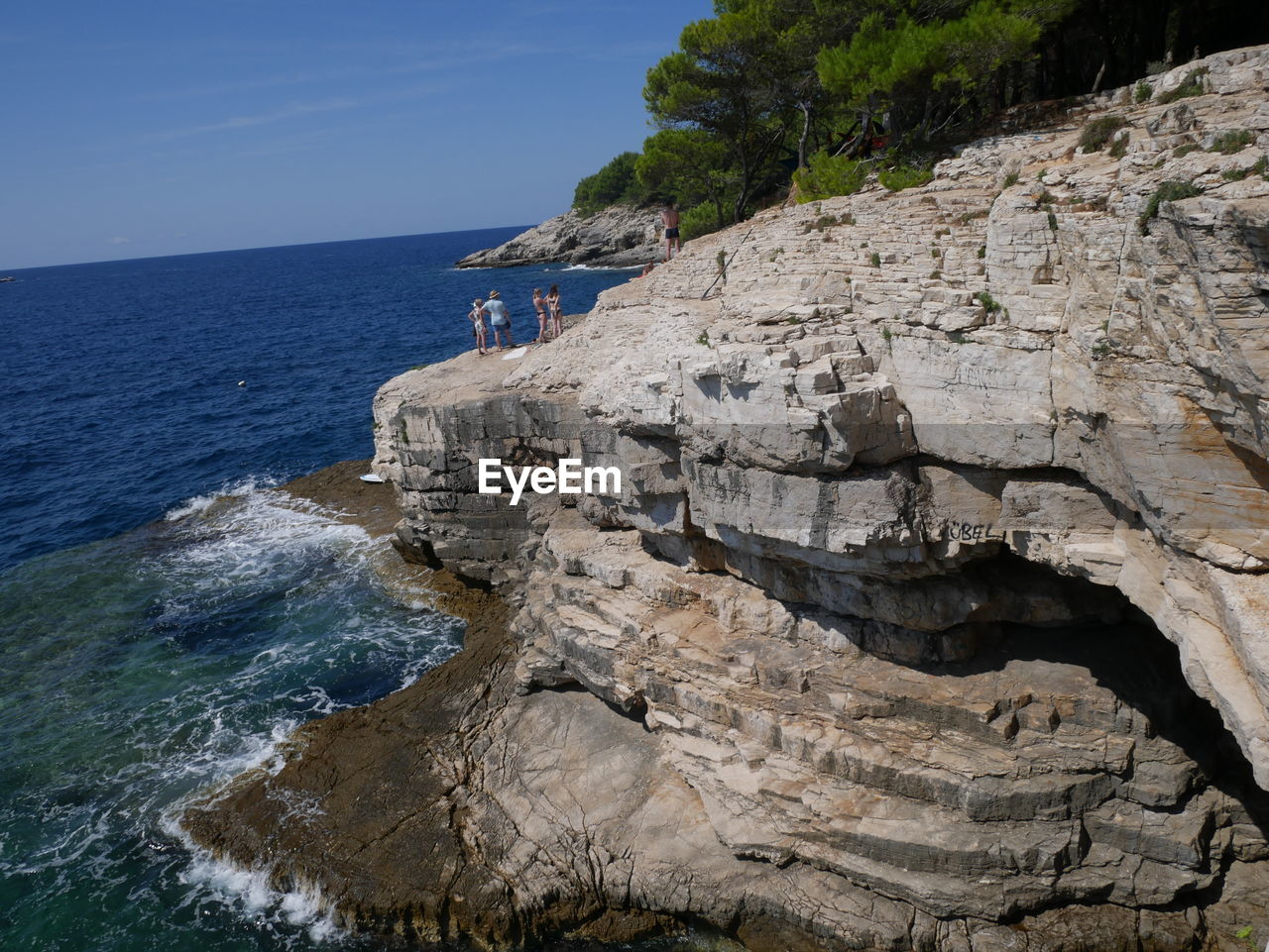 Rock formation on beach against sky