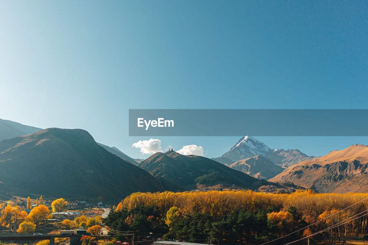 Scenic view of mountains against clear blue sky