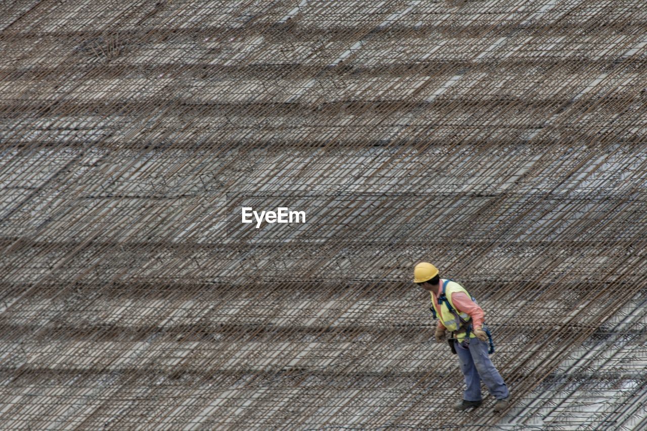 MAN WORKING AT CONSTRUCTION SITE