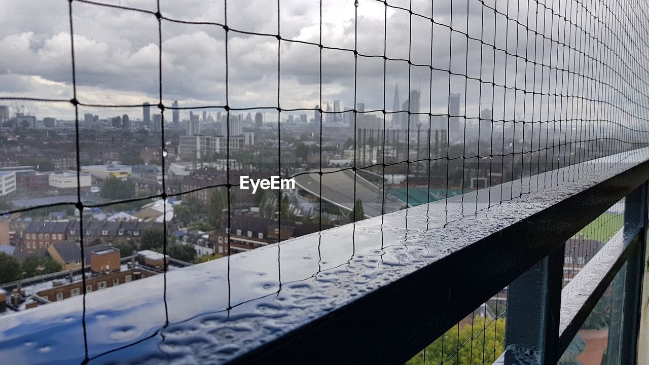 REFLECTION OF CLOUDS ON GLASS WINDOW