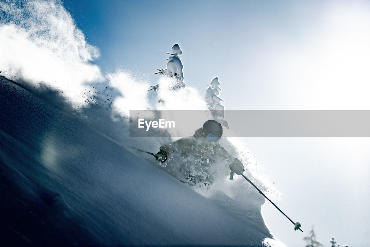 Adult man skiing in deep powder snow in the backcountry, werfenweng, austria.