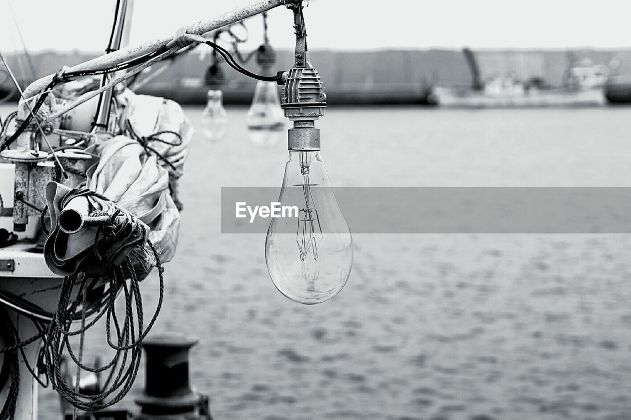 CLOSE-UP OF BICYCLE HANGING ON BOAT