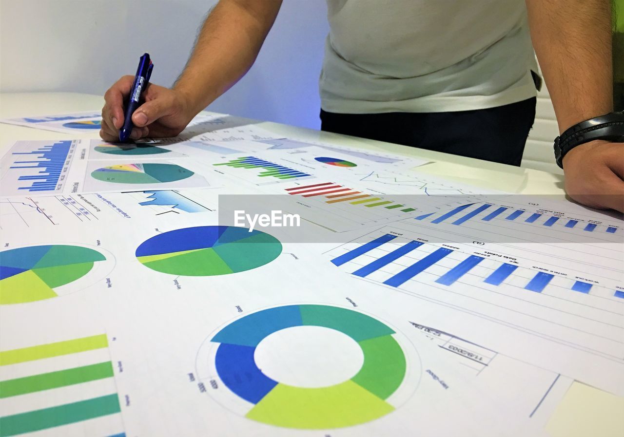 Midsection of businessman with color swatch at table