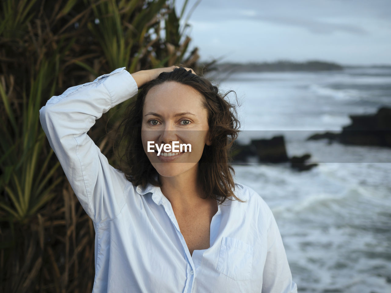 Portrait of woman at ocean coastline