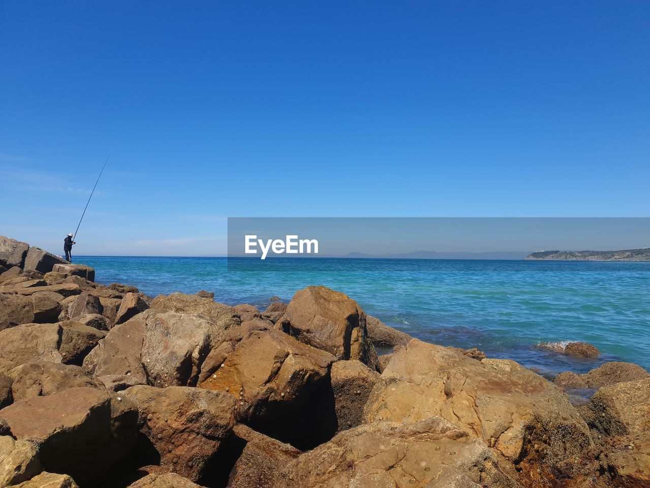 Scenic view of sea against clear blue sky
