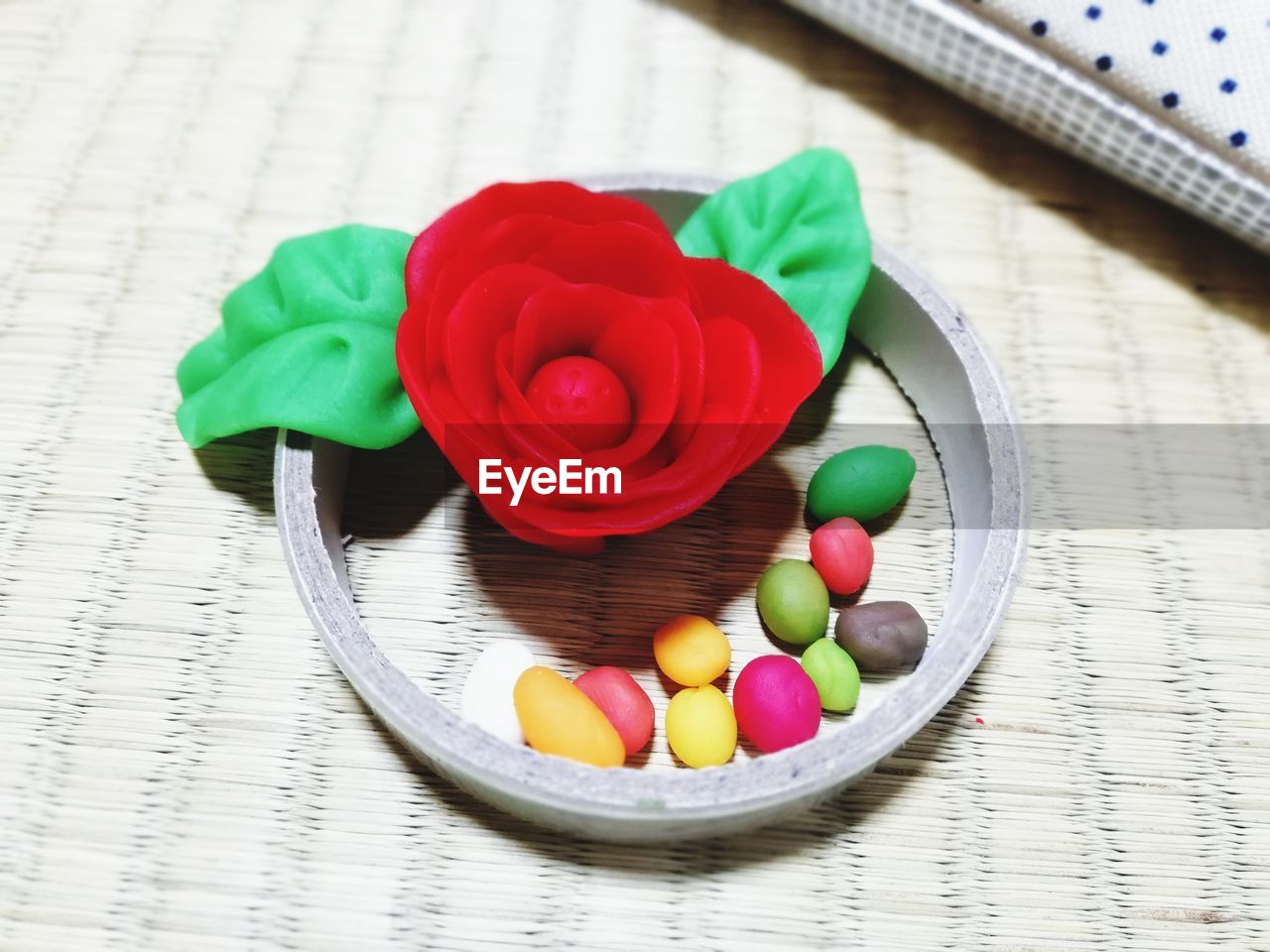 Red rose and colourful candy made from clay