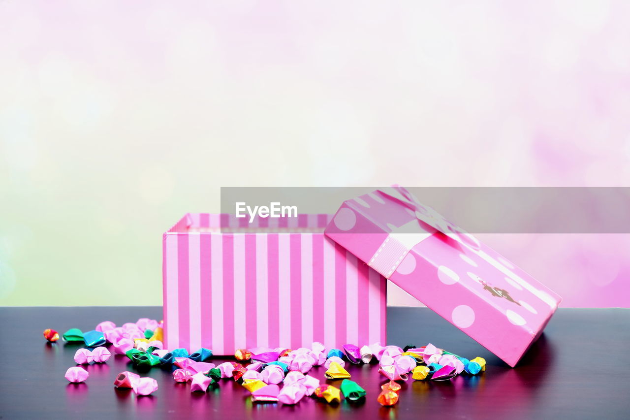 Close-up of pink gift box on table