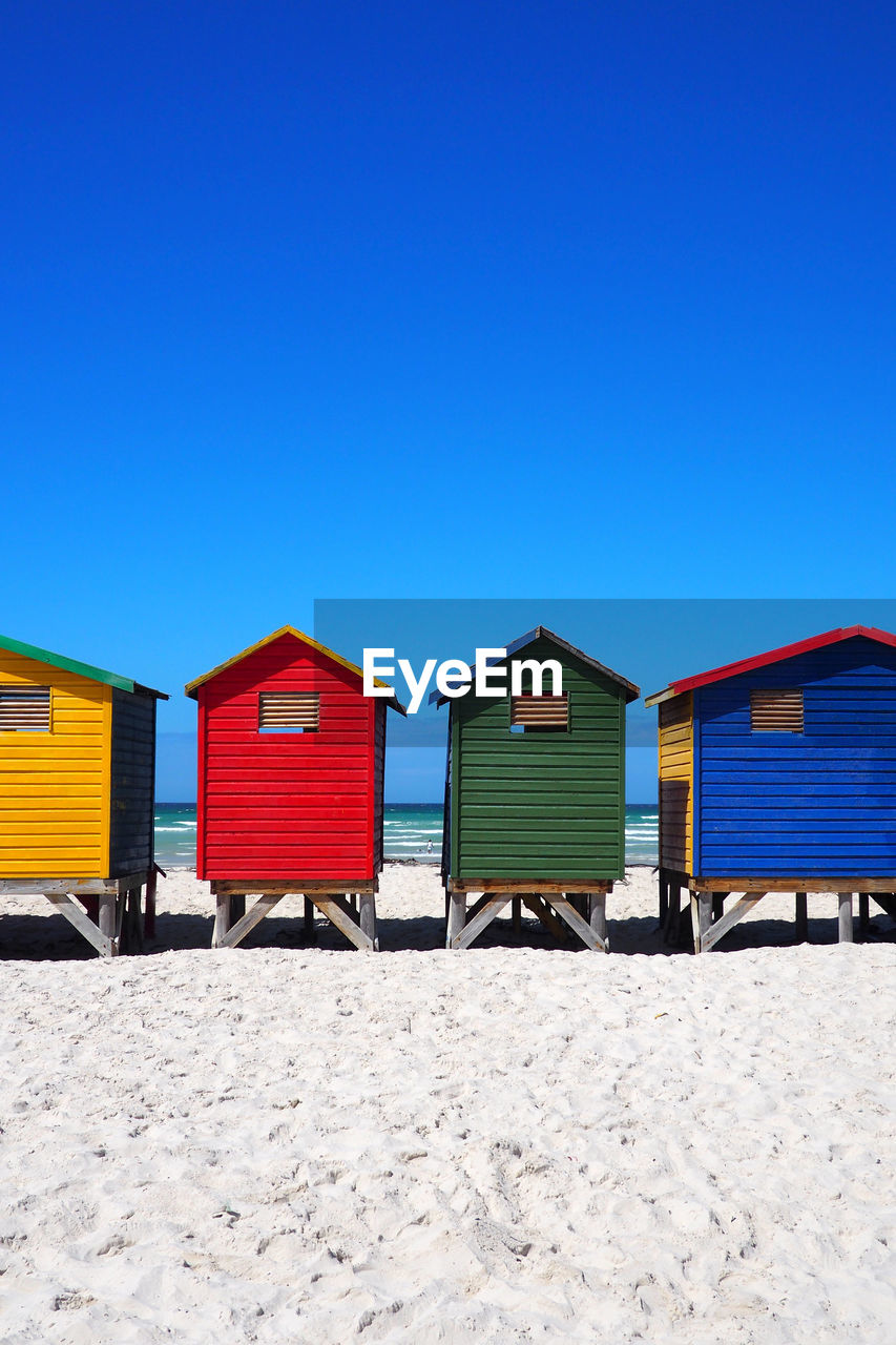 BEACH HUTS AGAINST SKY