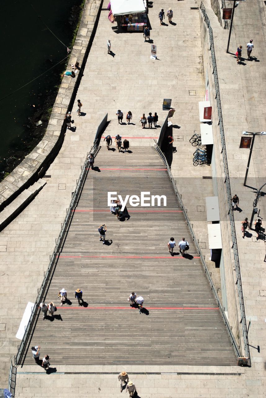 High angle view of people on staircase during sunny day