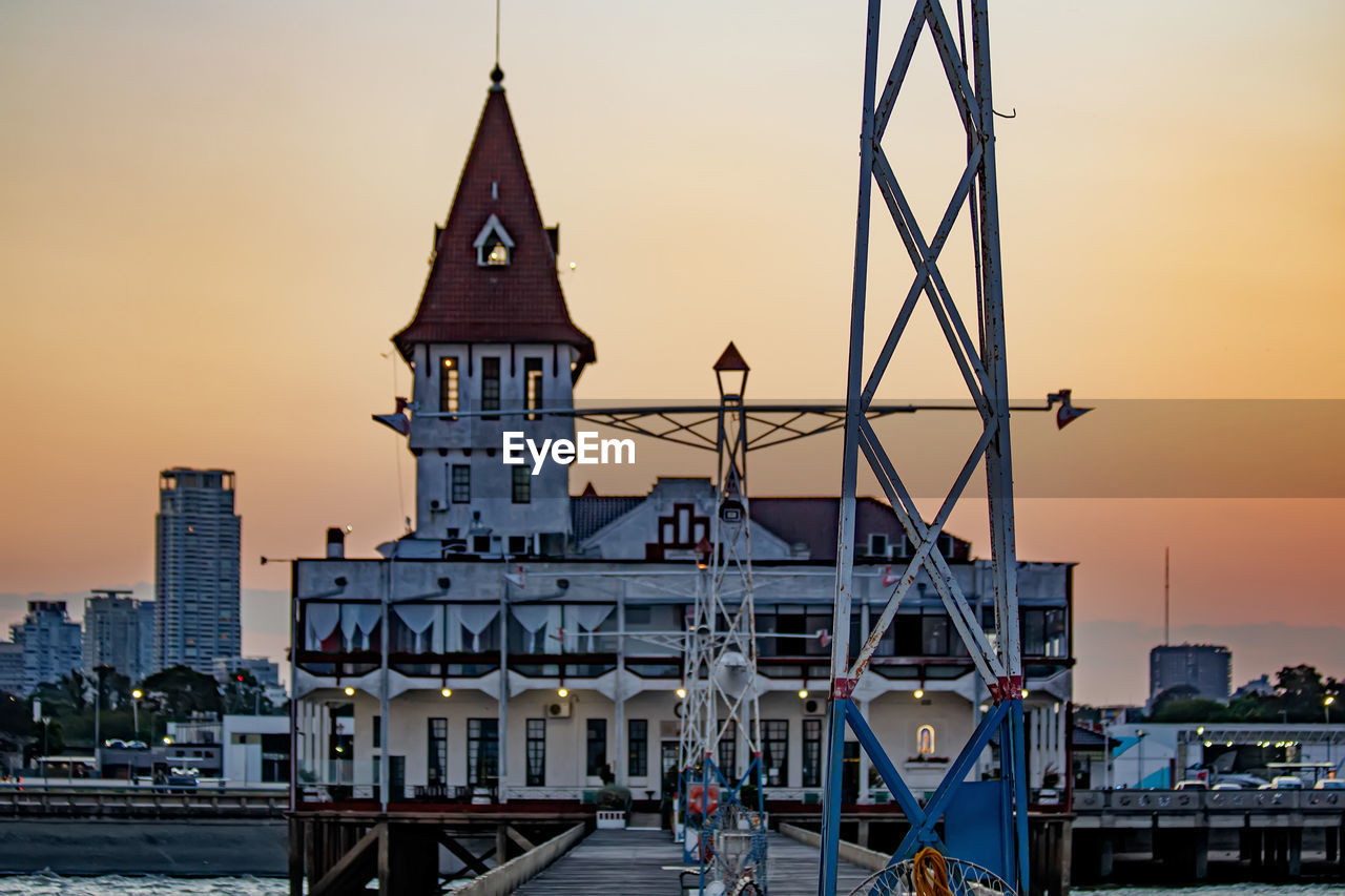 architecture, built structure, building exterior, city, cityscape, sunset, sky, building, water, landmark, travel destinations, evening, transportation, tower, skyline, nautical vessel, nature, travel, dusk, bridge, harbor, tourism, landscape, urban skyline, sea, mode of transportation, history, the past, twilight, ship, outdoors, place of worship, no people, business finance and industry, pier, urban area, religion, night, vehicle, reflection, waterway, boat, city life, watercraft