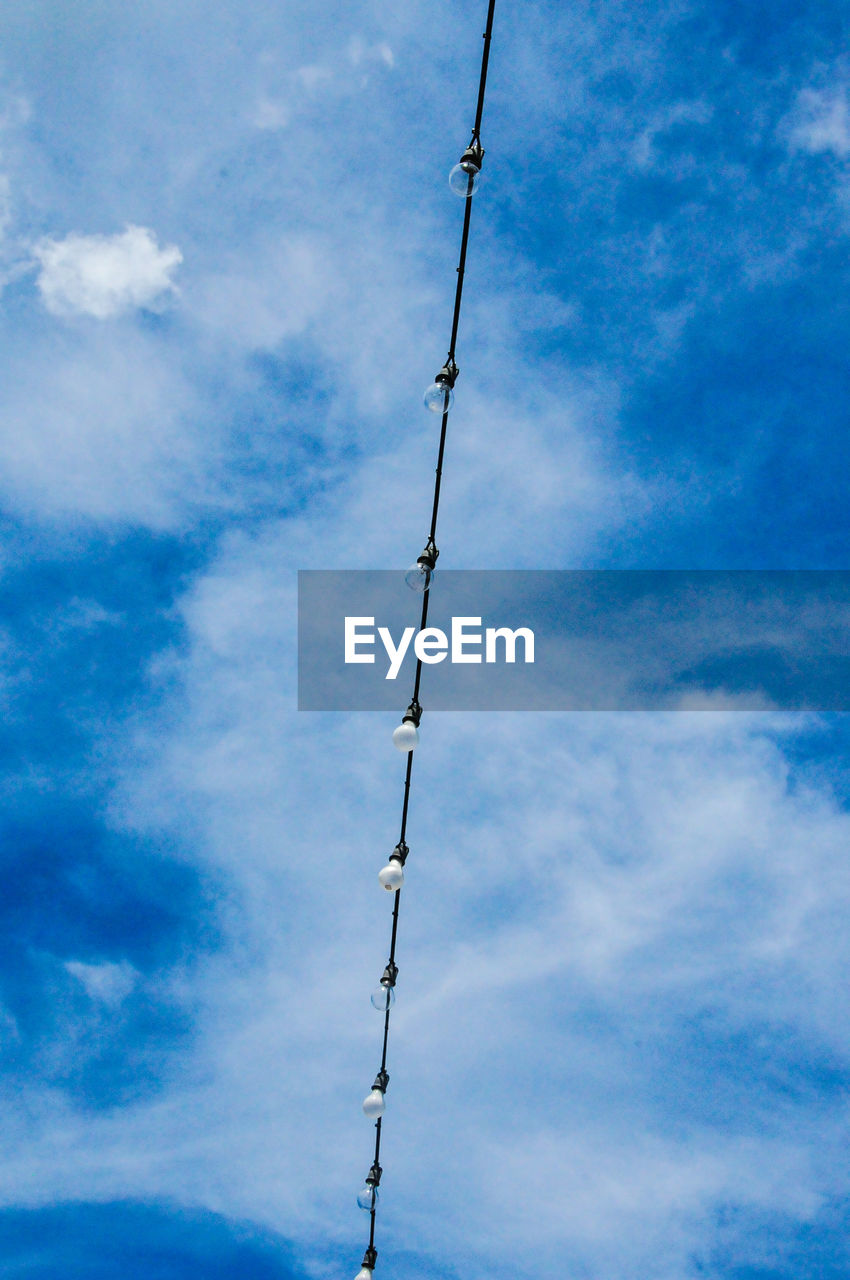 LOW ANGLE VIEW OF ELECTRICITY PYLON AGAINST CLOUDY SKY