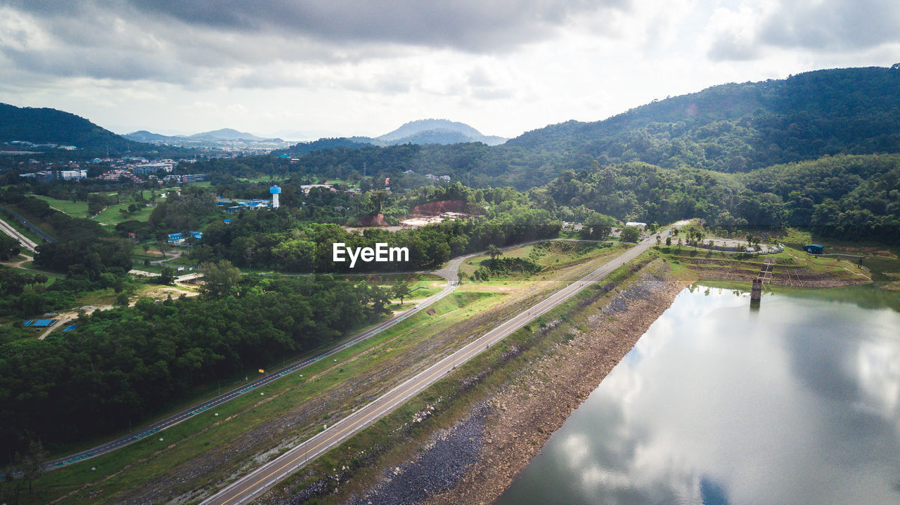 High view of a dam with all nature. mountain, water and forest