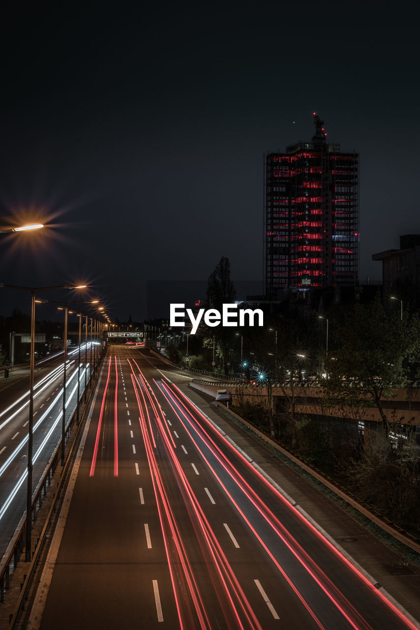 Light trails on road in city at night