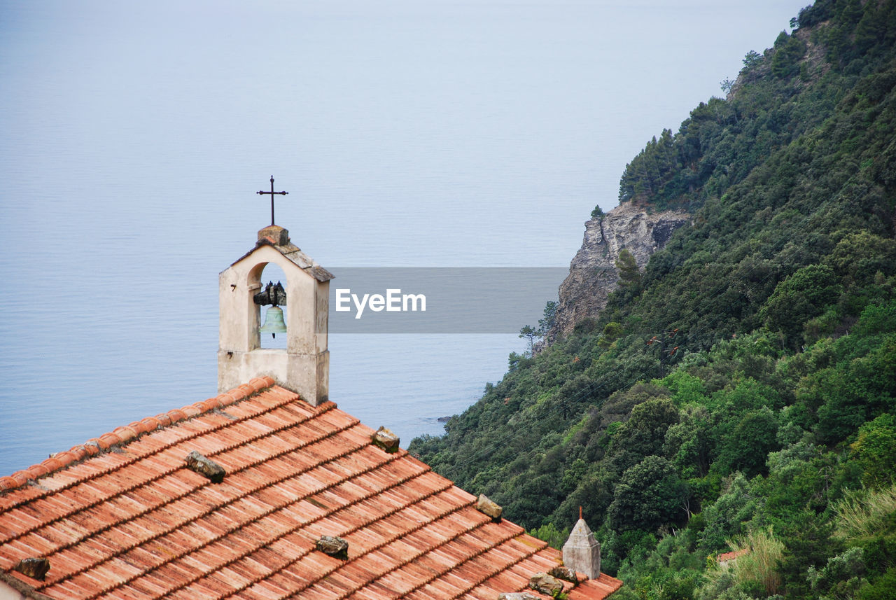 Little church, green mountain and the ligurian sea at setta in framura, la spezia, italy.