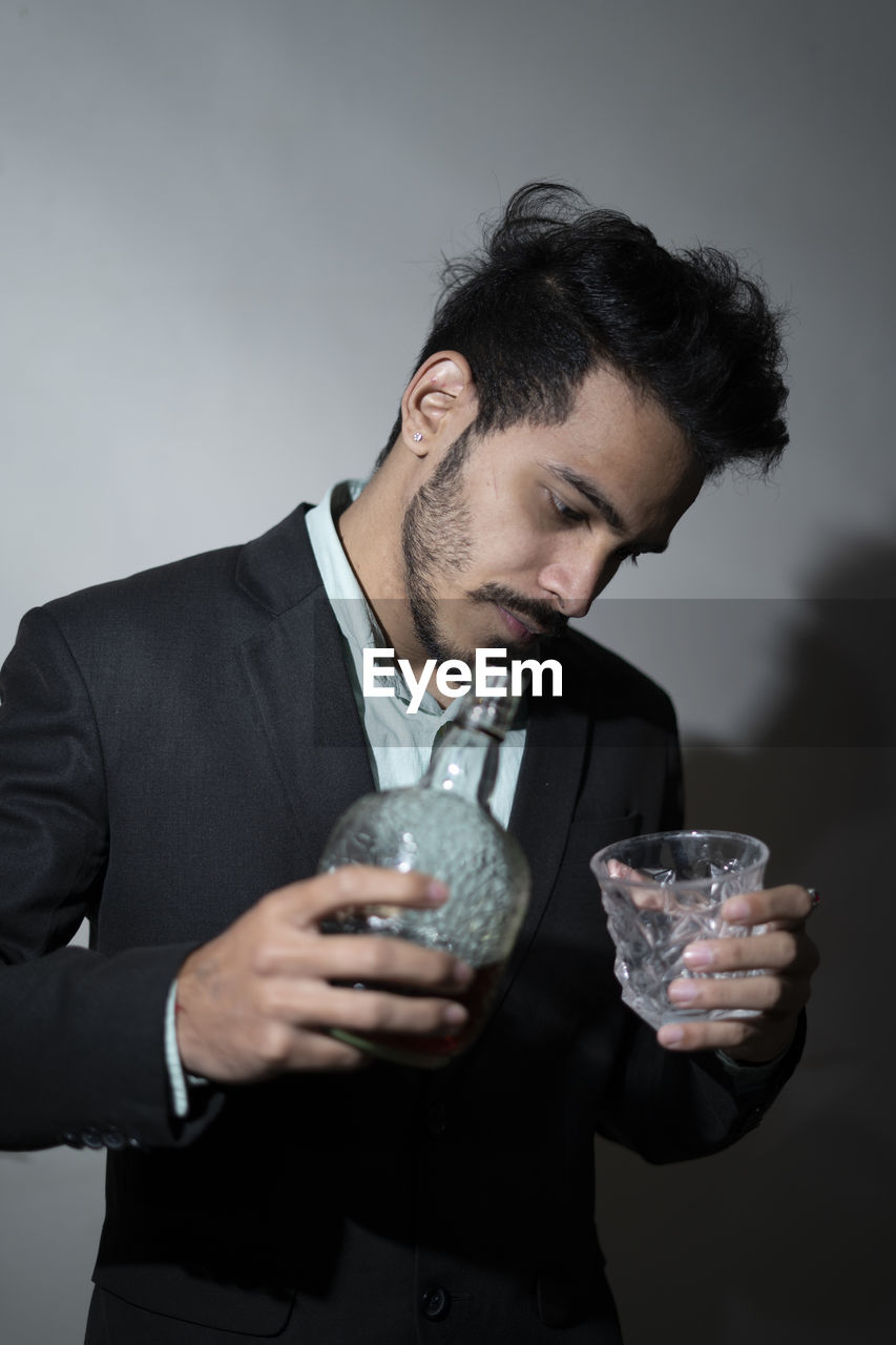 Closeup of a man's hand and pouring wine into the glass. office party concept