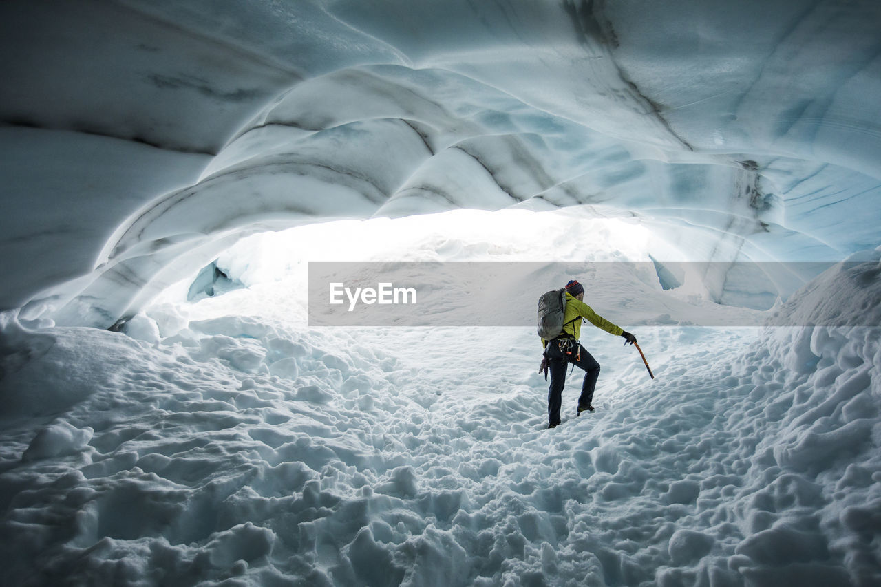 Climber, paul mcsorley, explores an ice cave on a mountaineering trip.