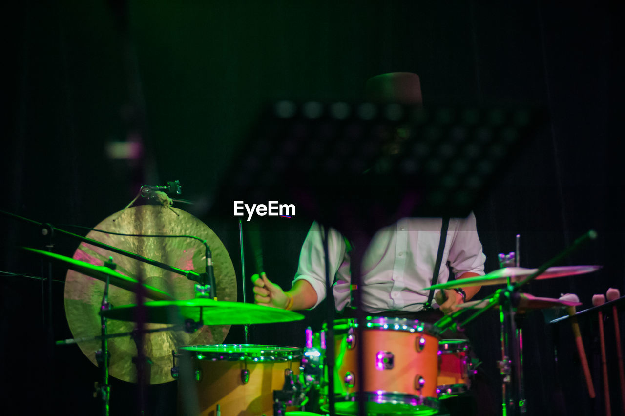 Man playing drums during concert