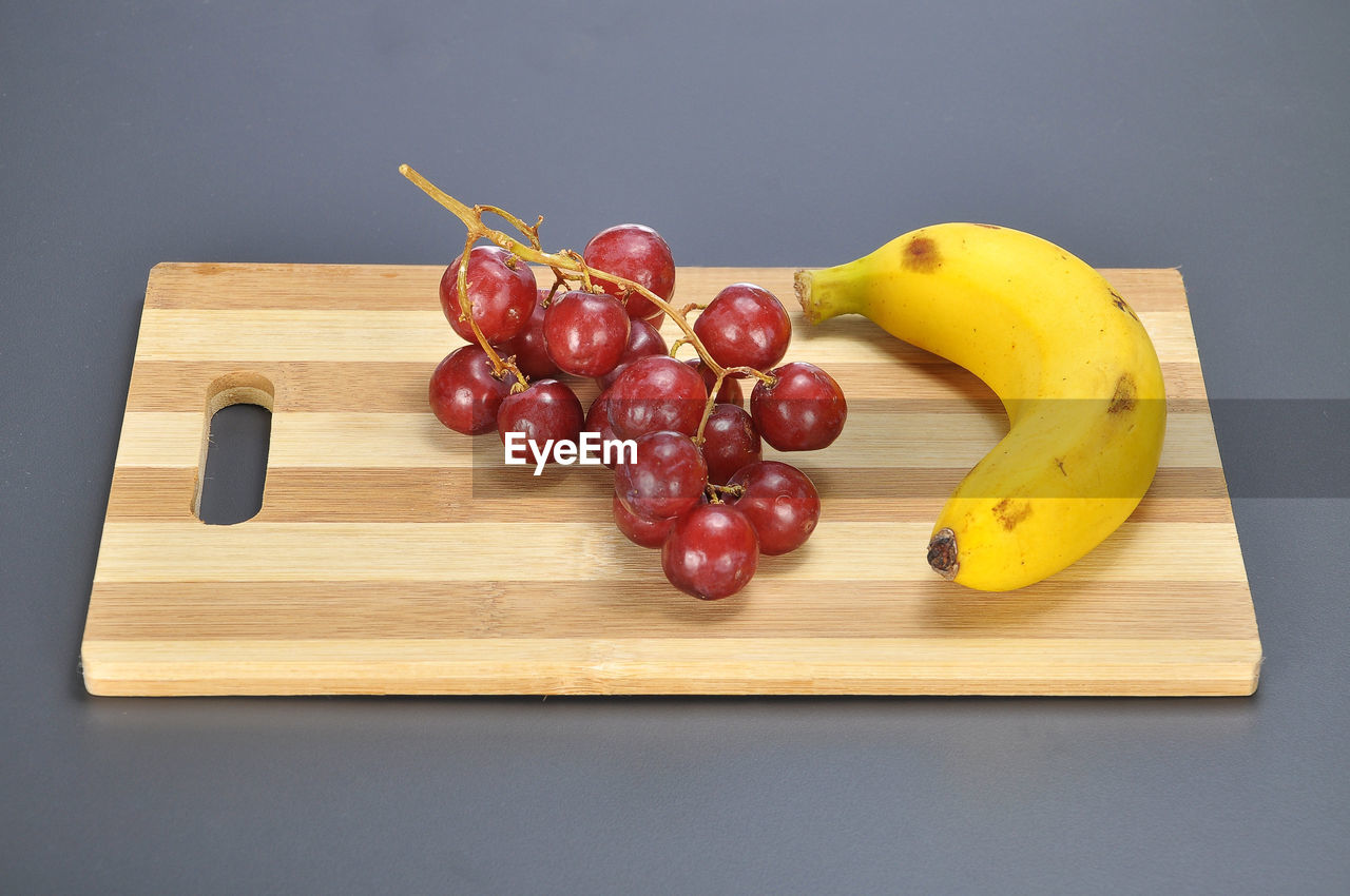 Close-up of fruits on wooden cupboard