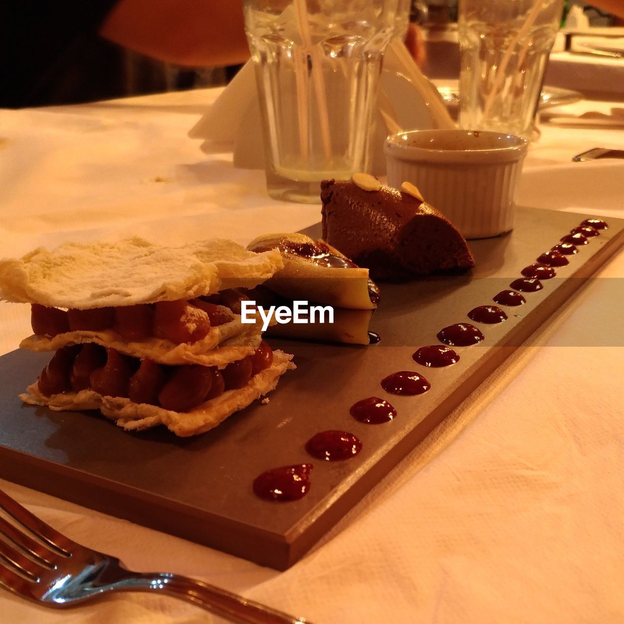 CLOSE-UP OF ICE CREAM ON TABLE