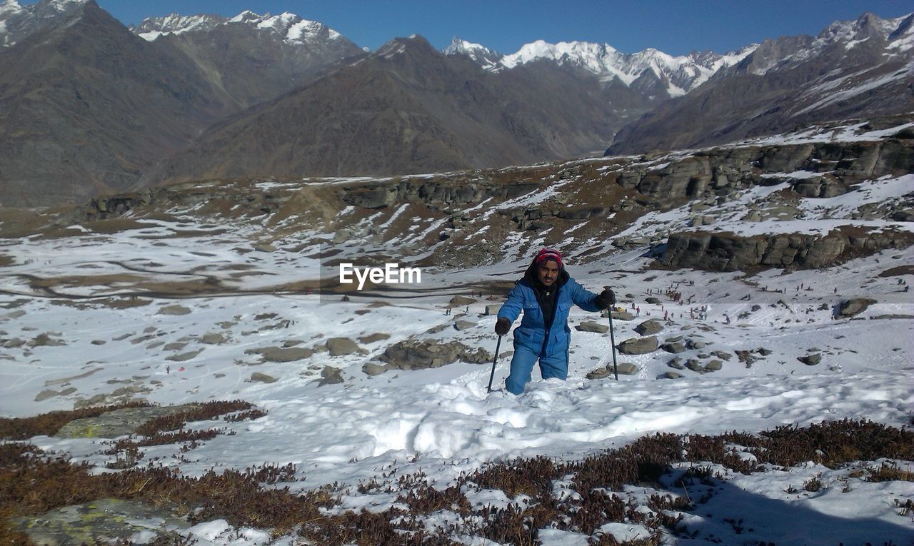 Full length of man on snowcapped mountains during winter