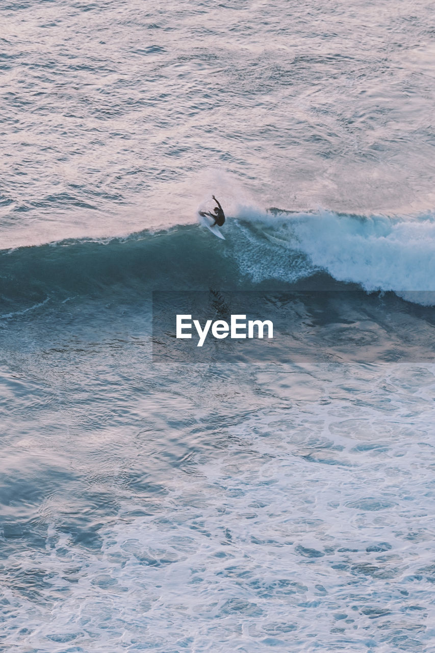 High angle view of man surfing on sea