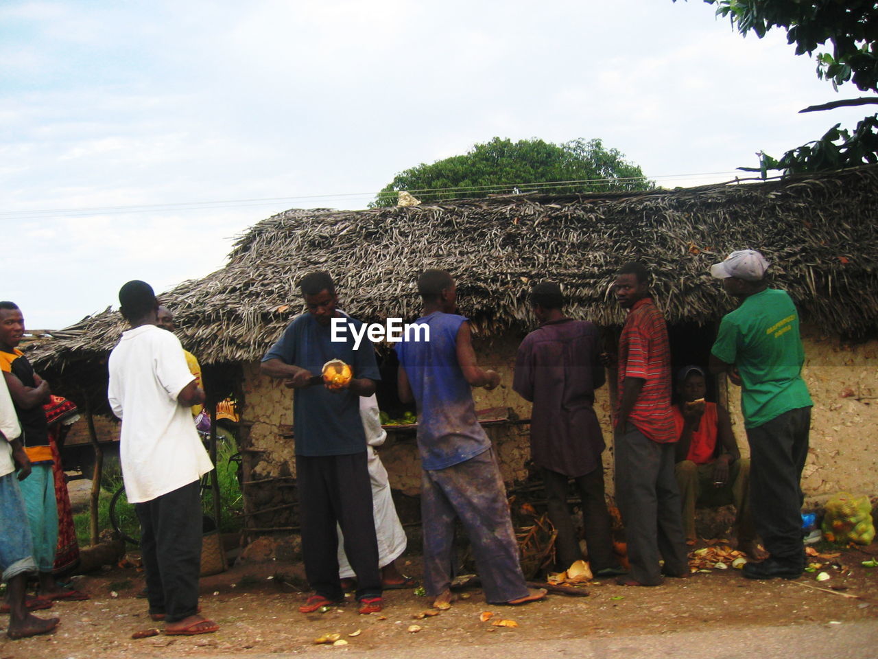 REAR VIEW OF PEOPLE STANDING AGAINST TREES