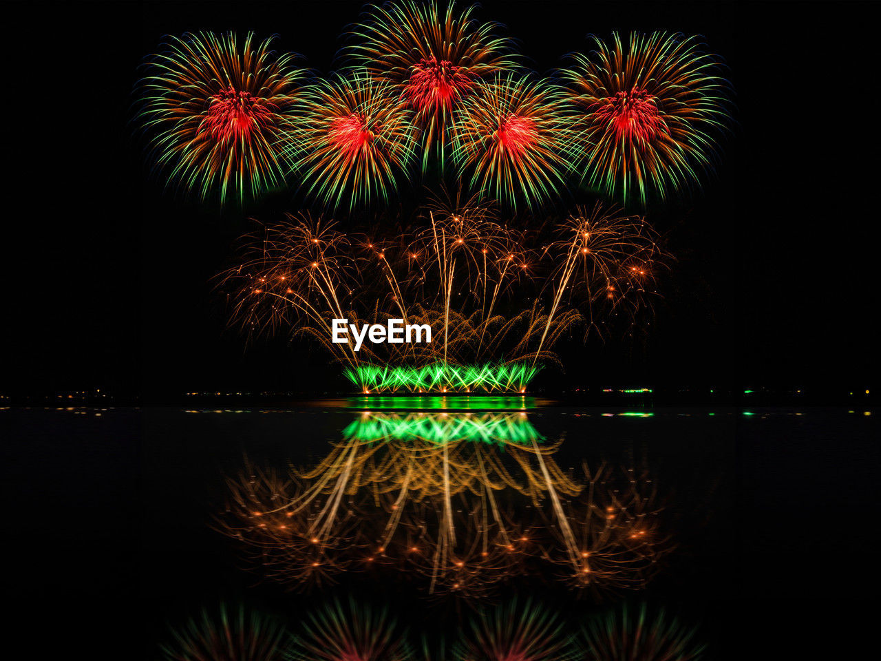 reflection of firework display over river at night