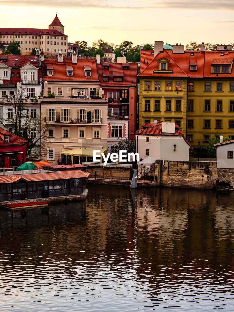 RIVER BY BUILDINGS AGAINST SKY