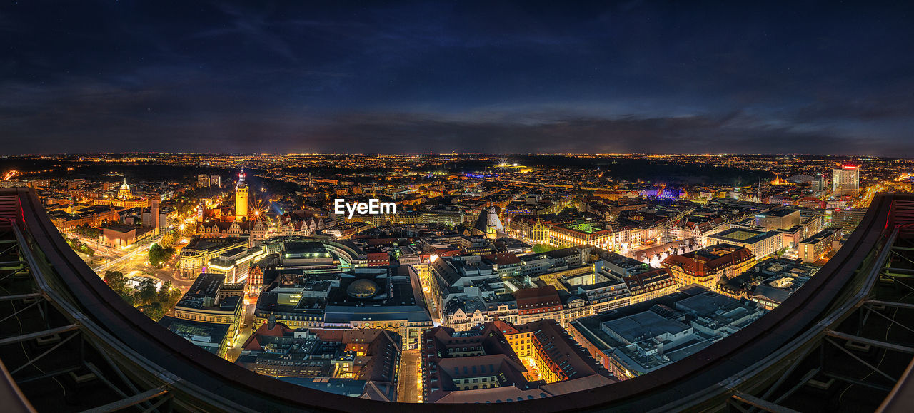 HIGH ANGLE VIEW OF ILLUMINATED BUILDINGS IN CITY AT NIGHT