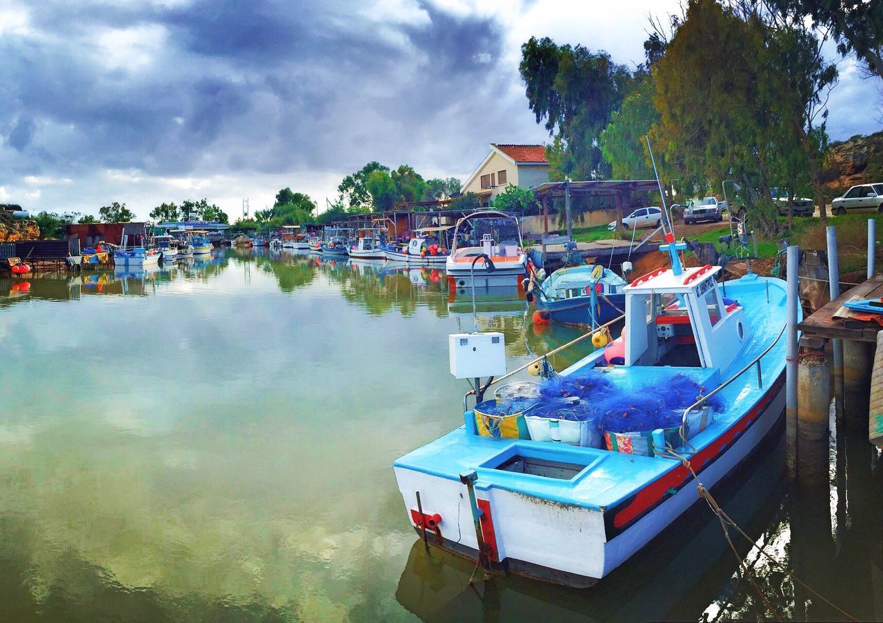 BOATS MOORED IN RIVER