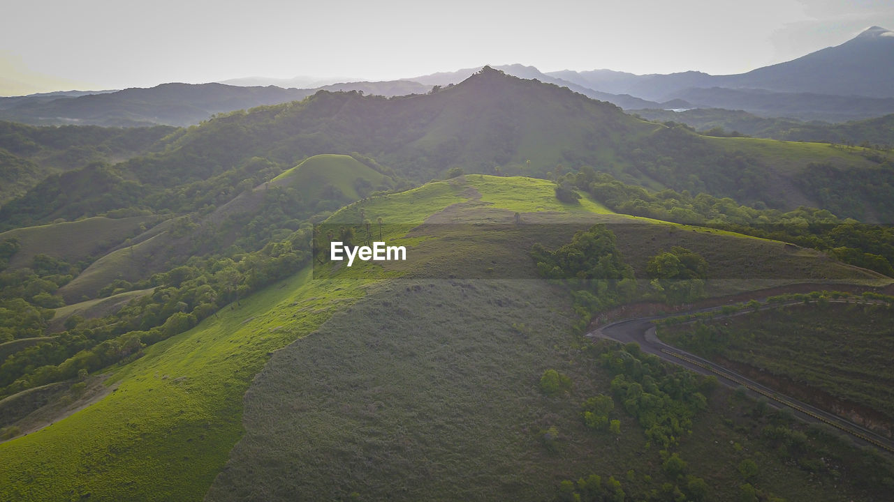 SCENIC VIEW OF LANDSCAPE AND MOUNTAINS AGAINST SKY