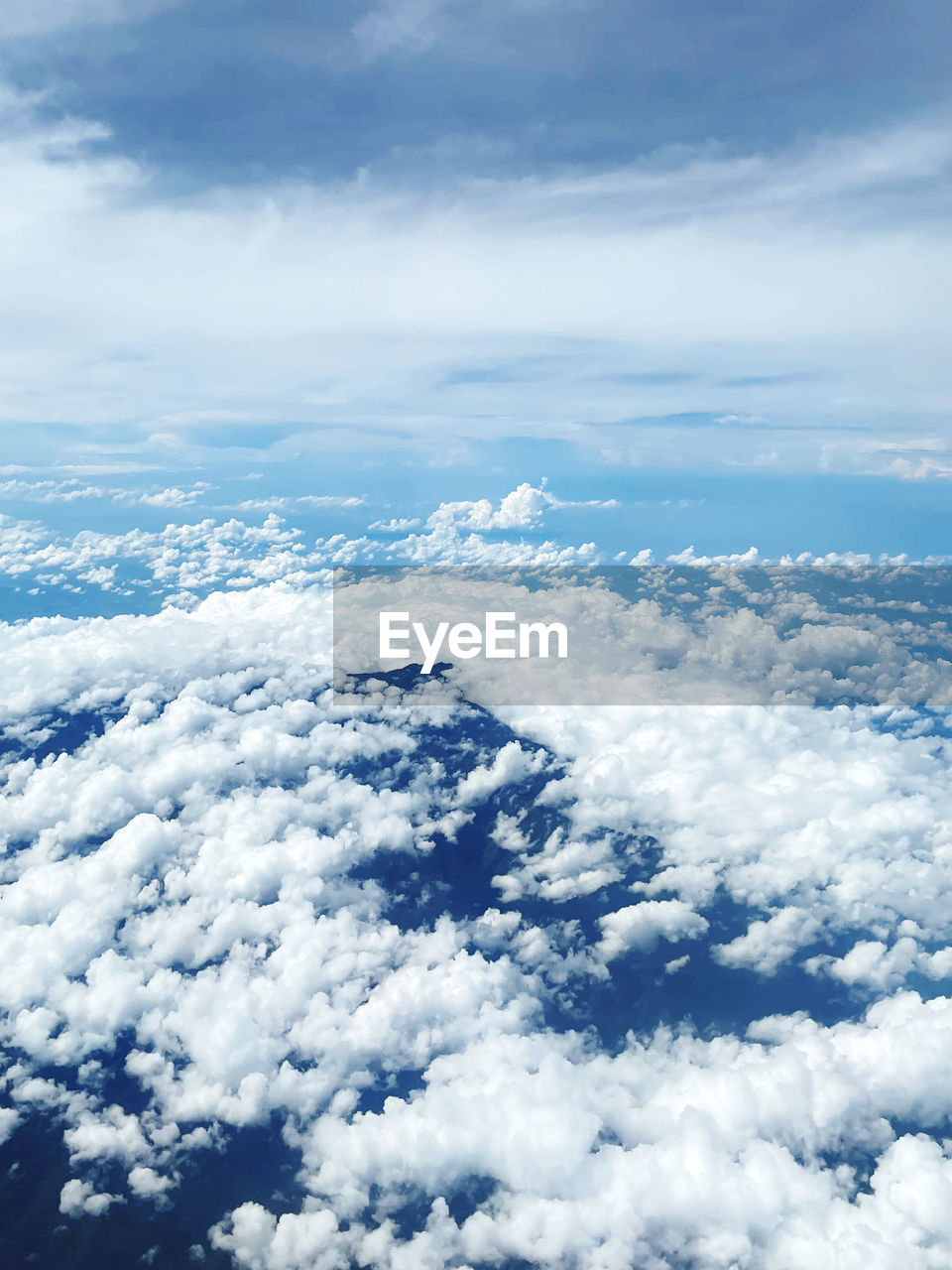 sky, cloud, aerial view, cloudscape, environment, scenics - nature, beauty in nature, nature, white, airplane, landscape, horizon, blue, no people, high angle view, high up, travel, outdoors, air vehicle, overcast, cold temperature, mountain range, idyllic, snow, day, atmosphere, tranquility, winter, flying, tranquil scene, transportation, backgrounds, fluffy, dramatic sky, plain, mountain