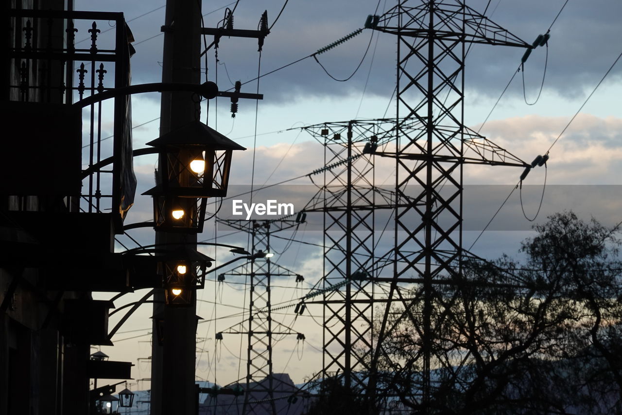 electricity, technology, electricity pylon, sky, silhouette, architecture, electrical supply, overhead power line, power generation, tower, power supply, transmission tower, cable, built structure, nature, no people, cloud, sunset, power line, communication, evening, dusk, outdoors, sign, outdoor structure, public utility, industry, low angle view, mast