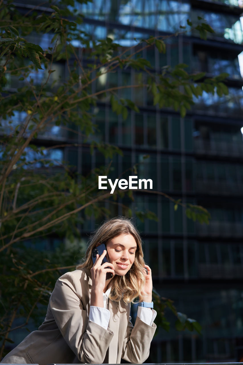 portrait of young woman using mobile phone