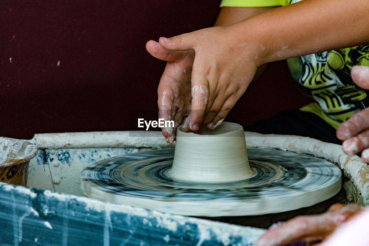 Close-up of man working on pottery wheel