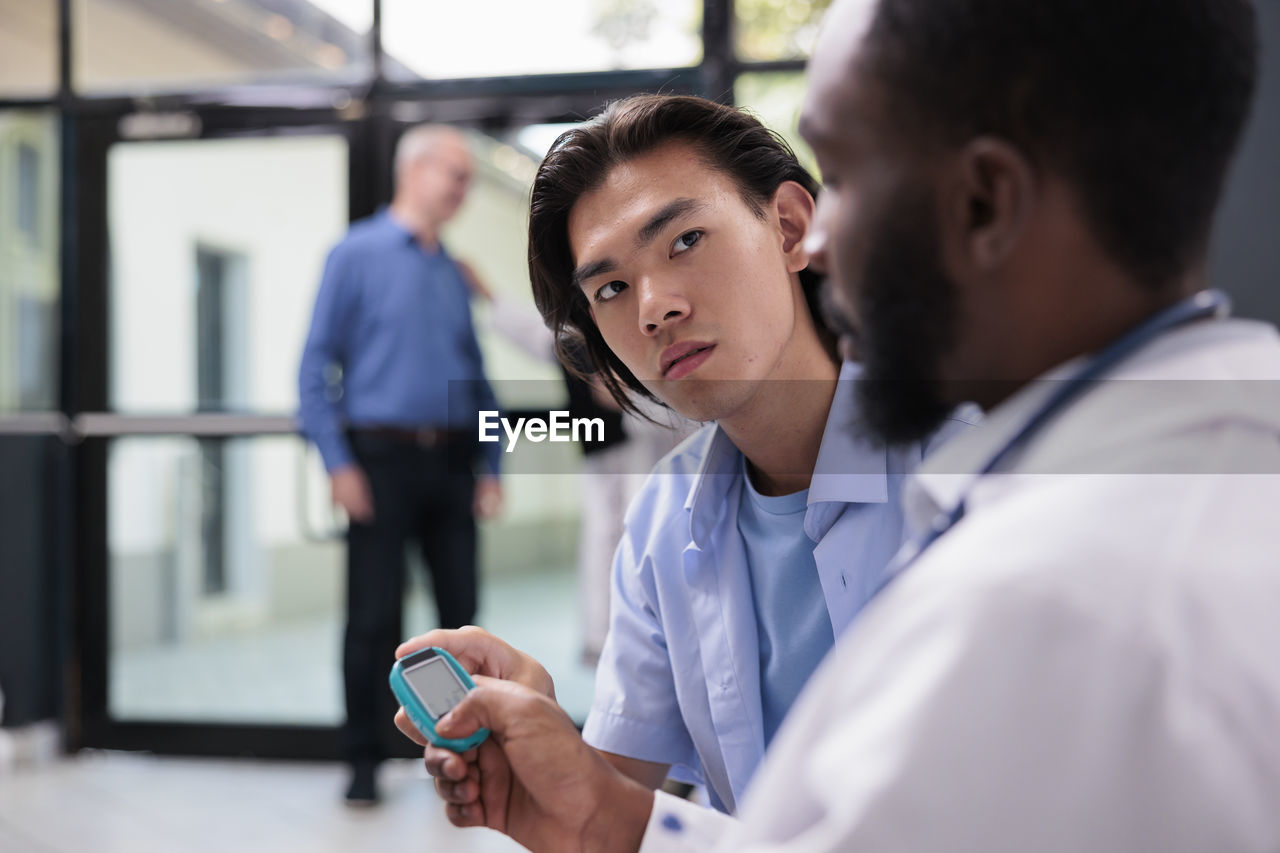 side view of doctor examining patient in laboratory