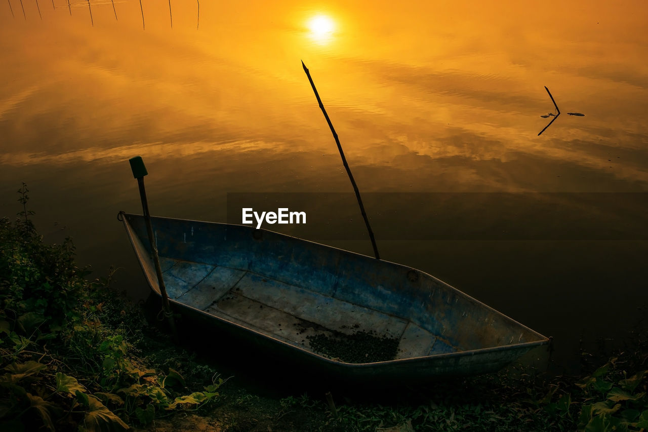 BOAT ON SEA SHORE DURING SUNSET