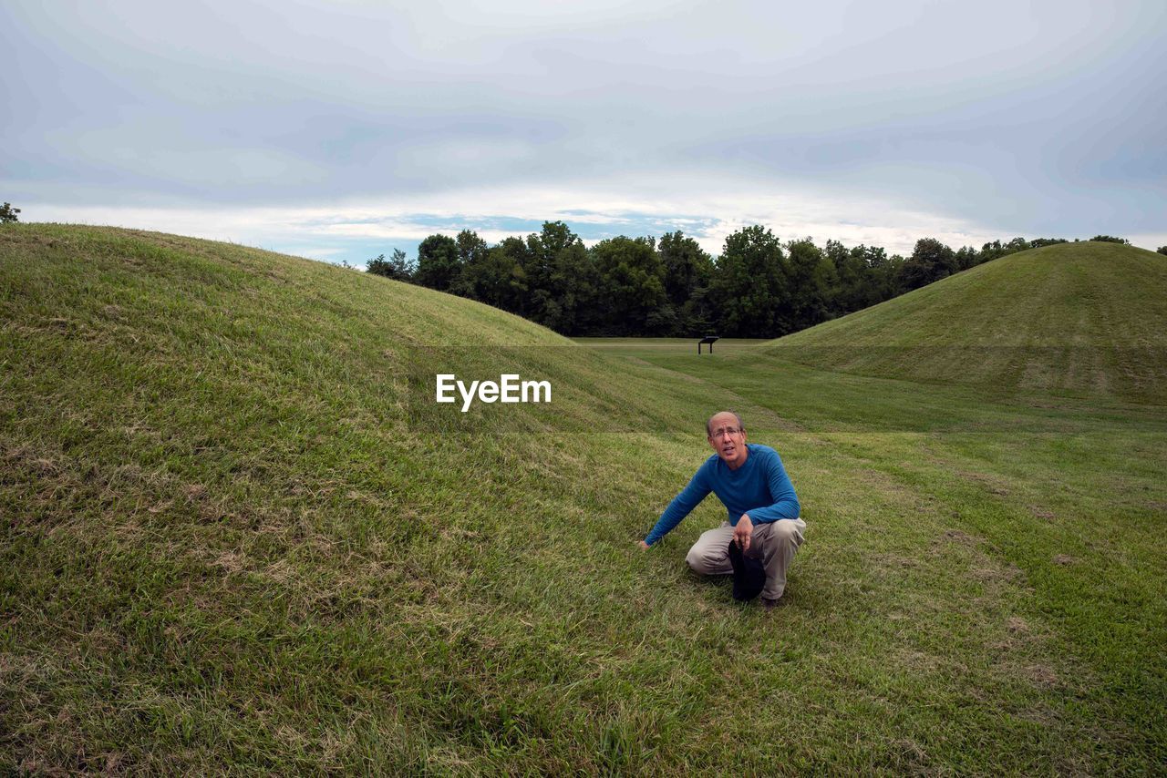 Man examines prehistoric native american burial mounds in mound city ohio