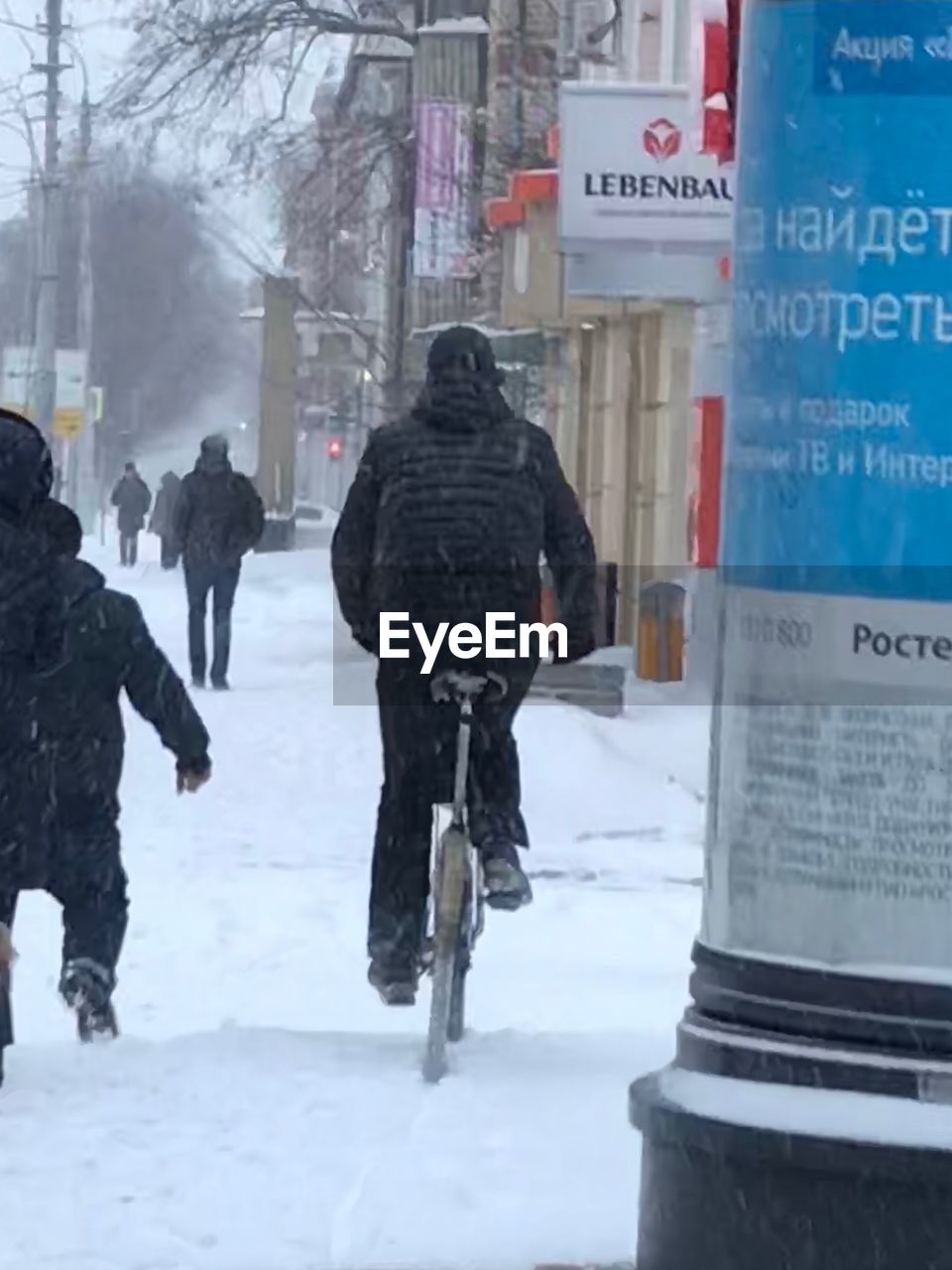 REAR VIEW OF PEOPLE WALKING ON SNOW