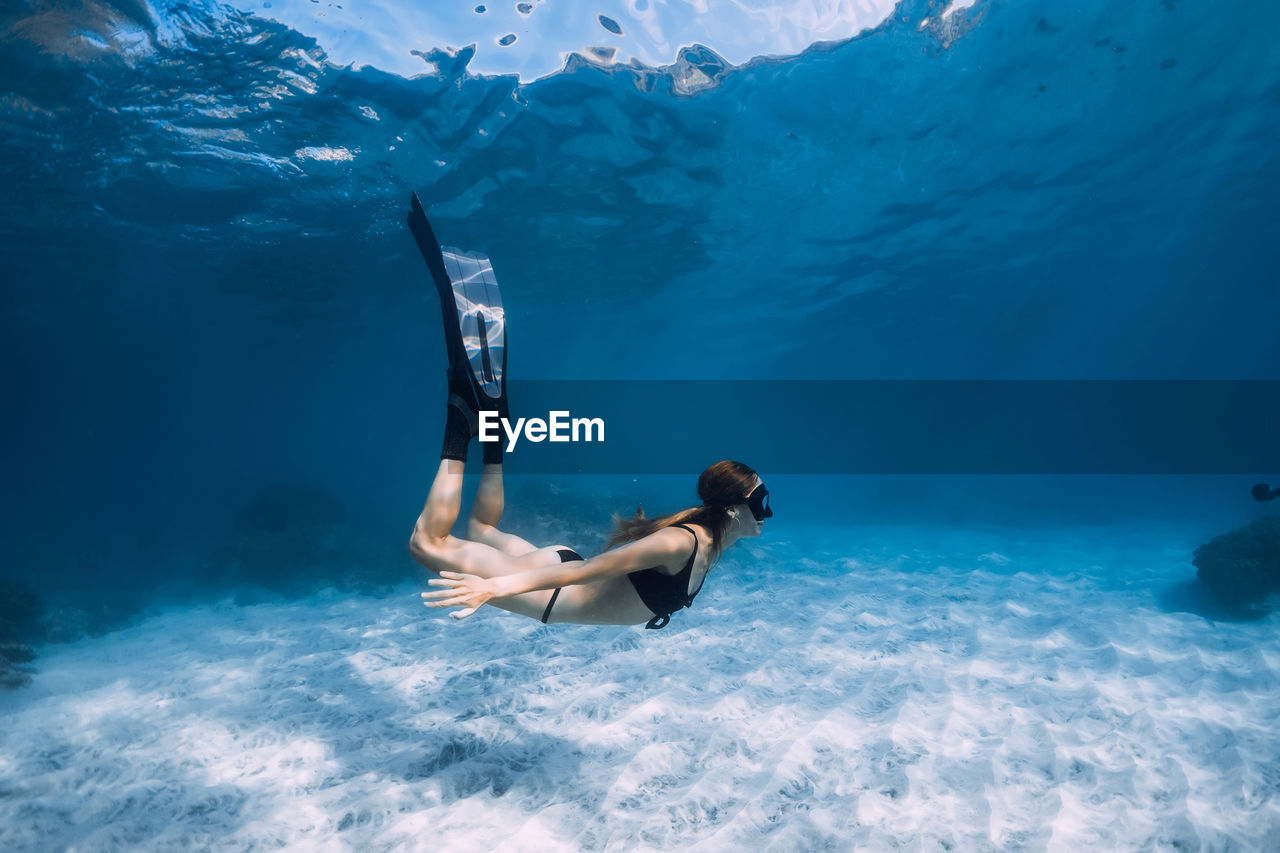 rear view of man swimming in sea