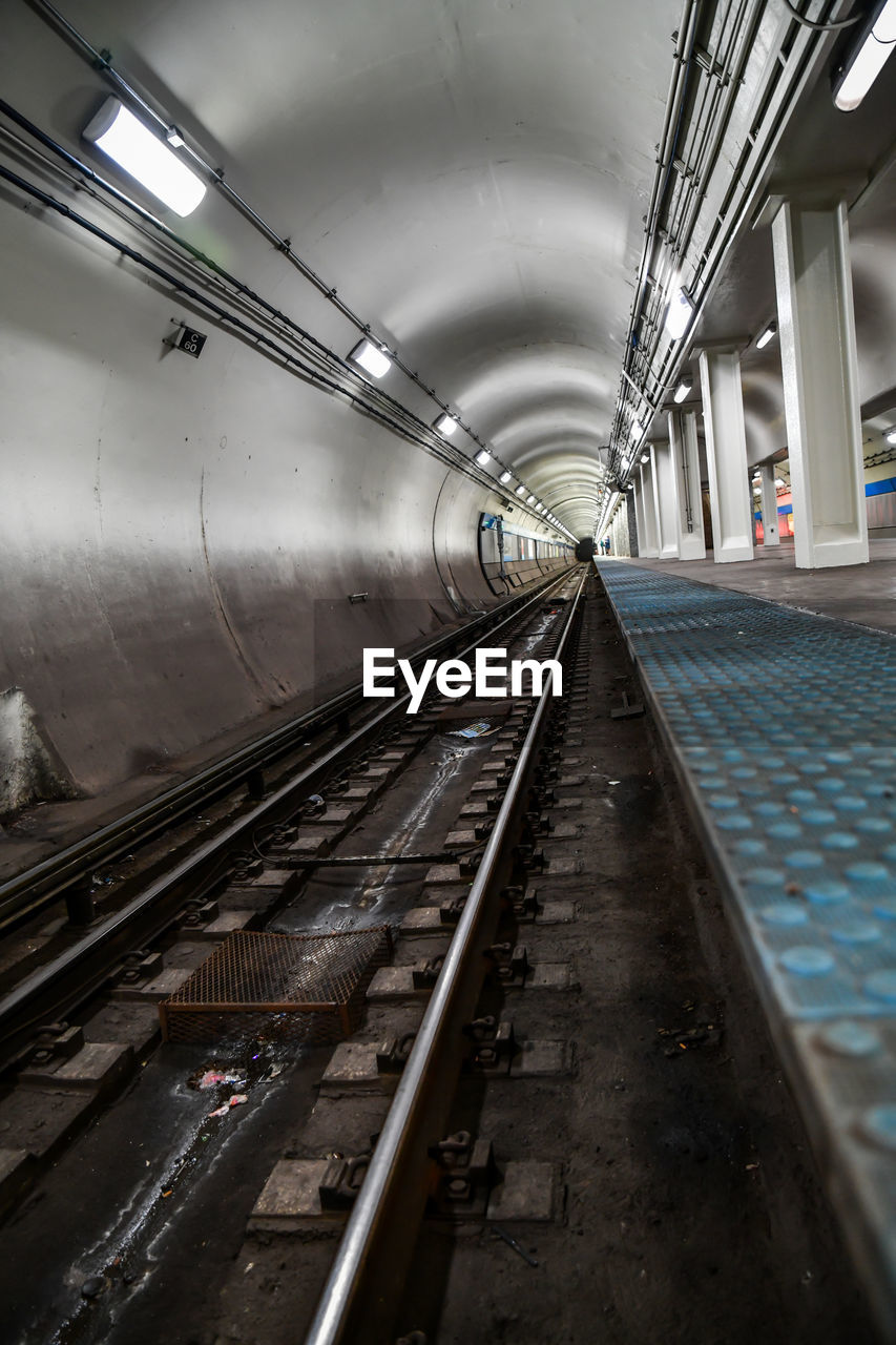 Empty urban subway train platform tunnel and tracks