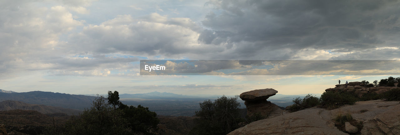 SCENIC VIEW OF MOUNTAINS AGAINST CLOUDY SKY