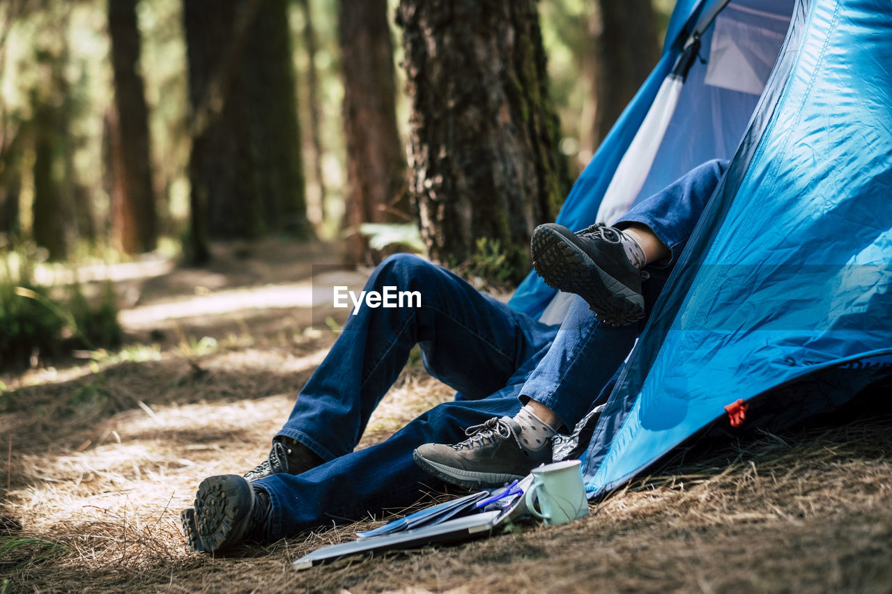 Low section of couple in tent on field