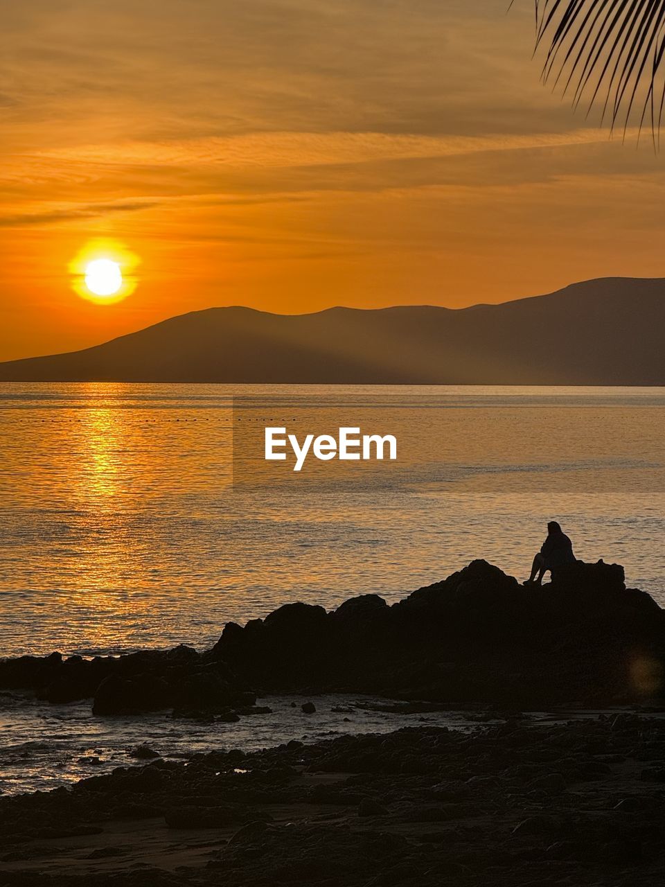 scenic view of beach against sky during sunset